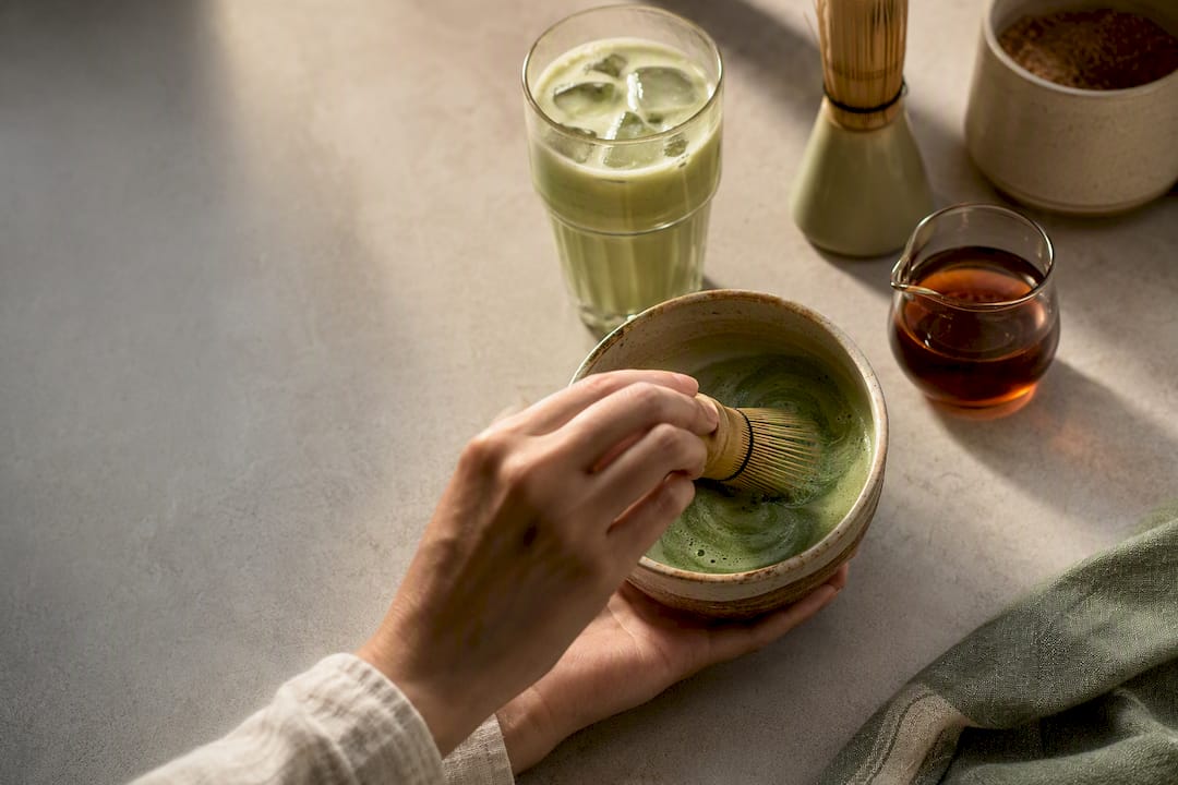 Panela-sweetened matcha latte being whisked