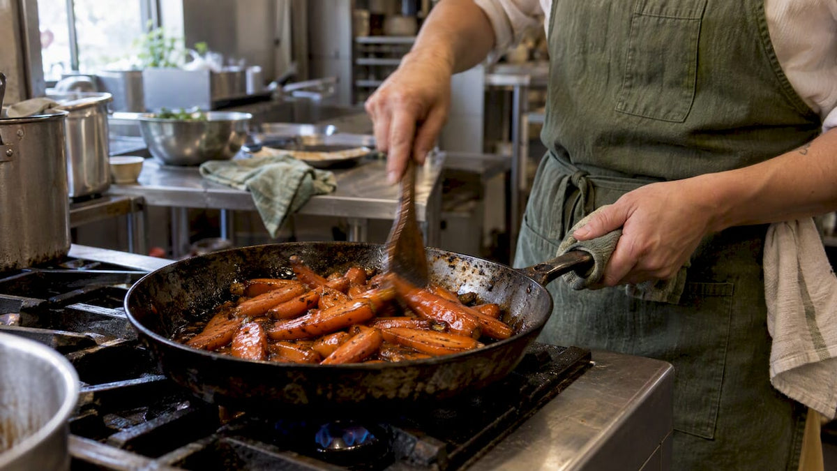 Glossy panela-glazed carrots in a skillet