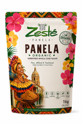 A 1 kg stand-up pouch of Zesté Panela Organic Unrefined Whole Cane Sugar, featuring a colorful tropical design with hibiscus flowers, a traditional colombian woman holding a bowl of sugar, and a church tower illustration.